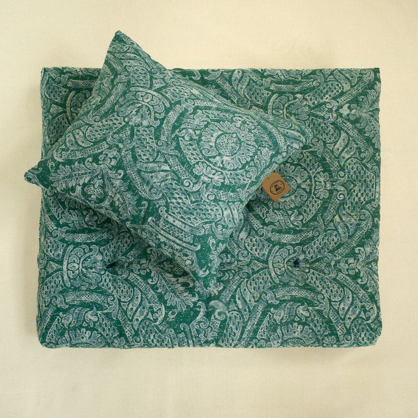 Green paisley patterned fabric decorative cushion and matching dog bed