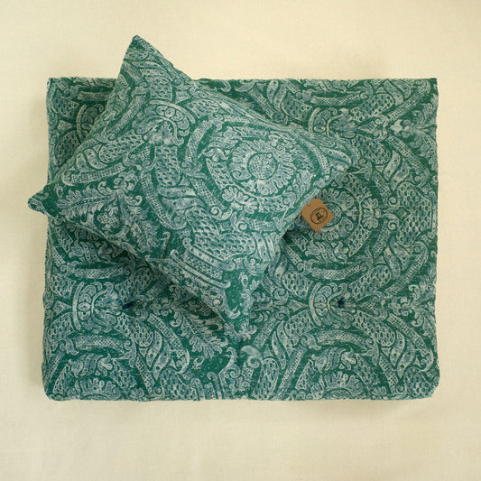 Green paisley patterned fabric decorative cushion and matching dog bed