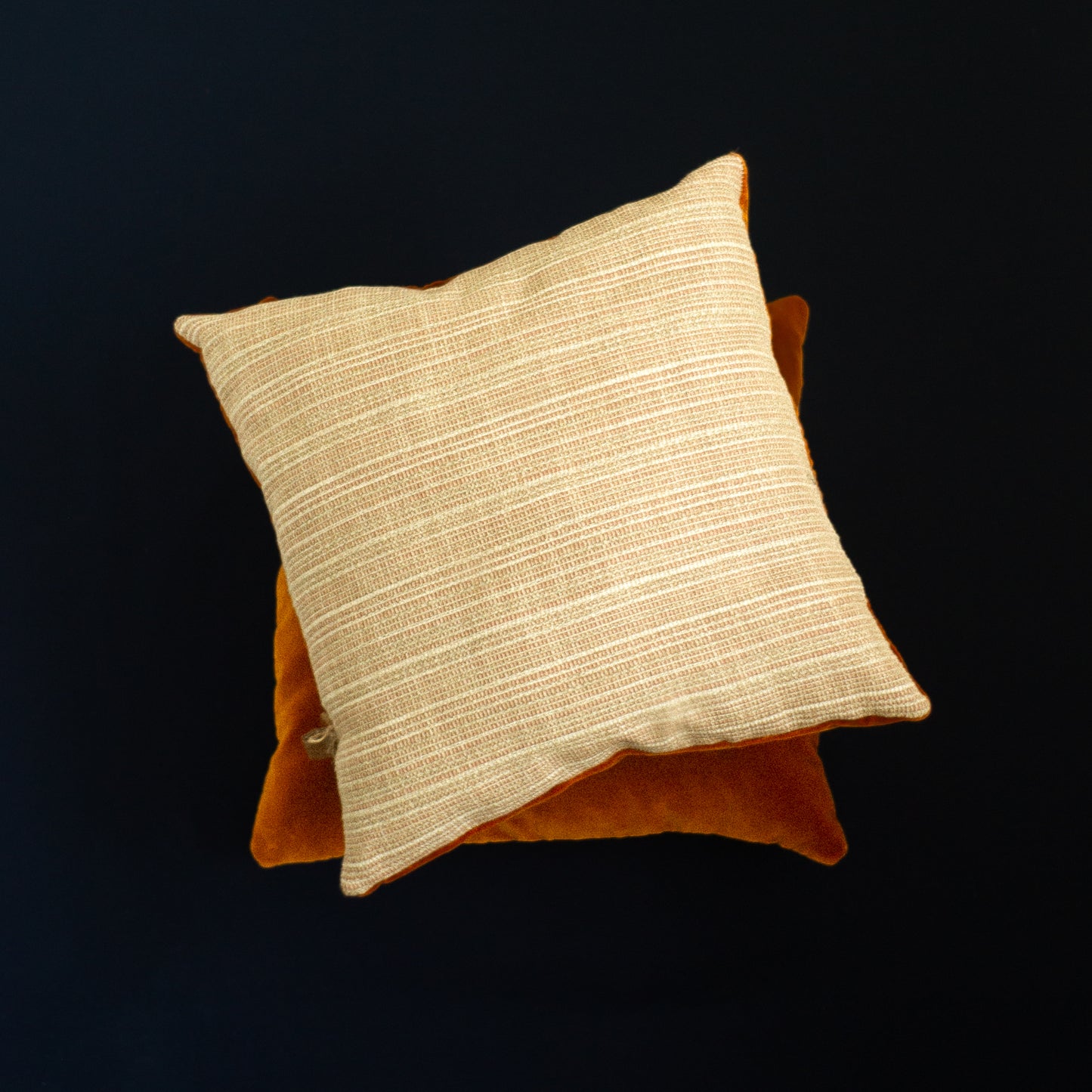 Beige and orange decorative pillows The Niche Society