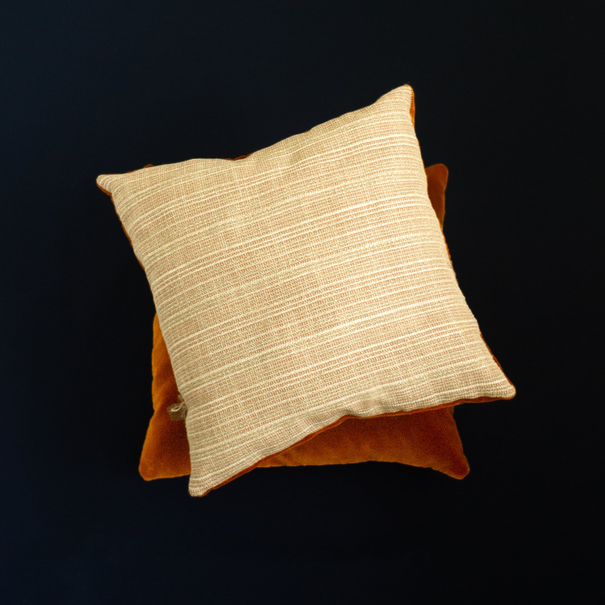 Beige and orange decorative pillows The Niche Society