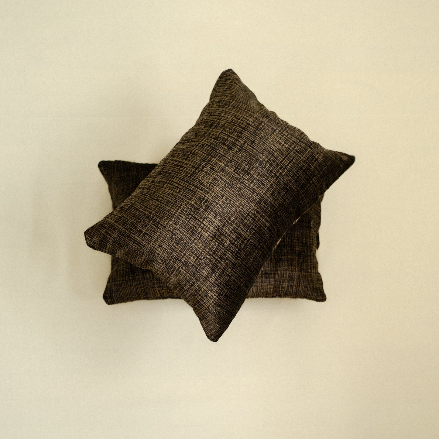 Two dark brown textured pillows