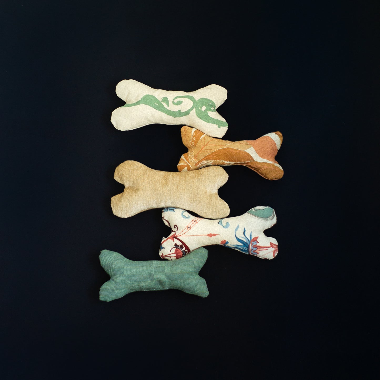 Five bone-shaped toys with different patterns for dogs