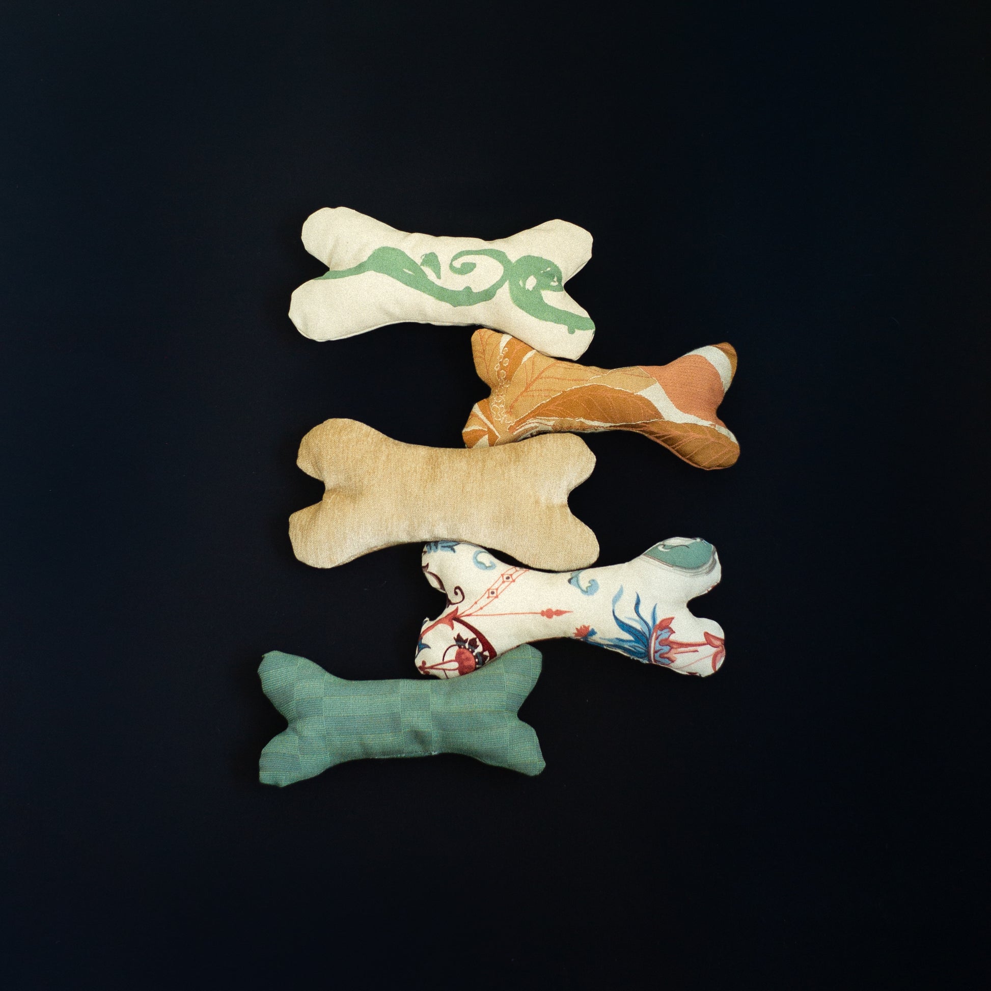 Five bone-shaped toys with different patterns for dogs
