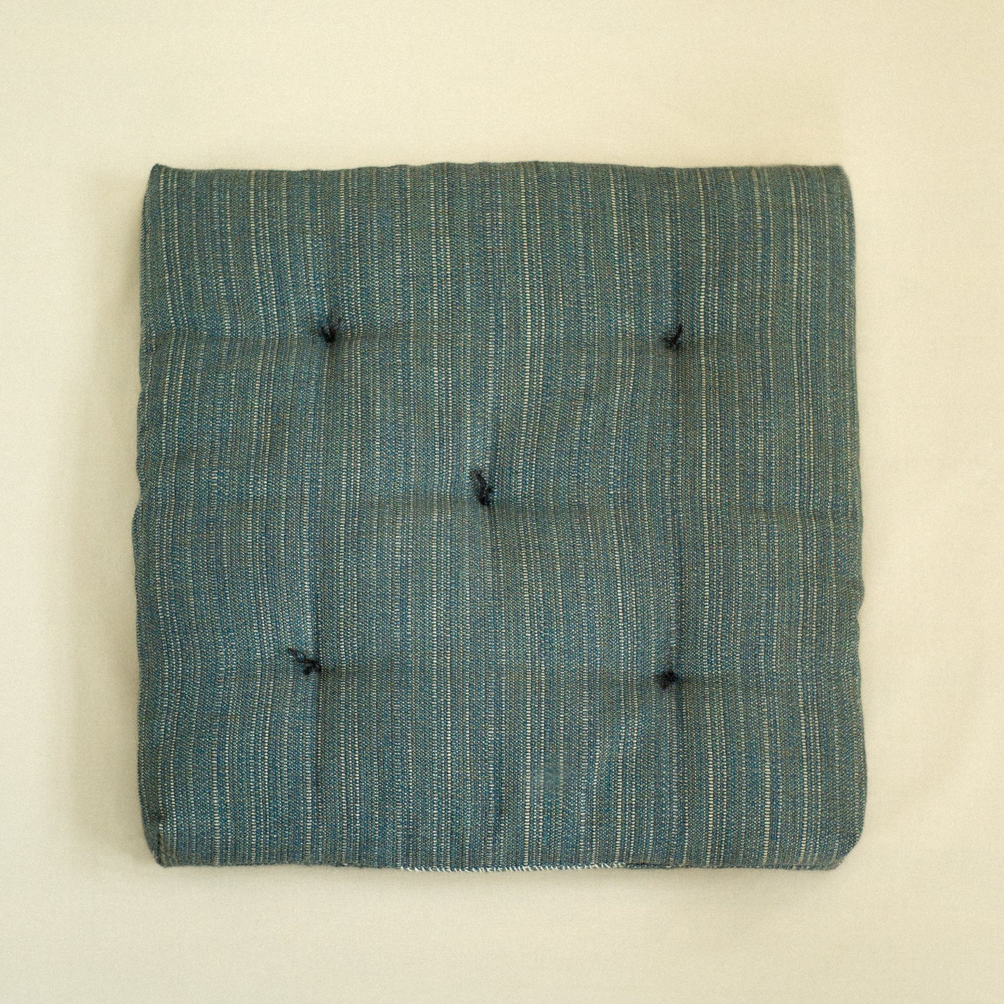 Teal textured dog bed with quilted detail filled with sheep wool.