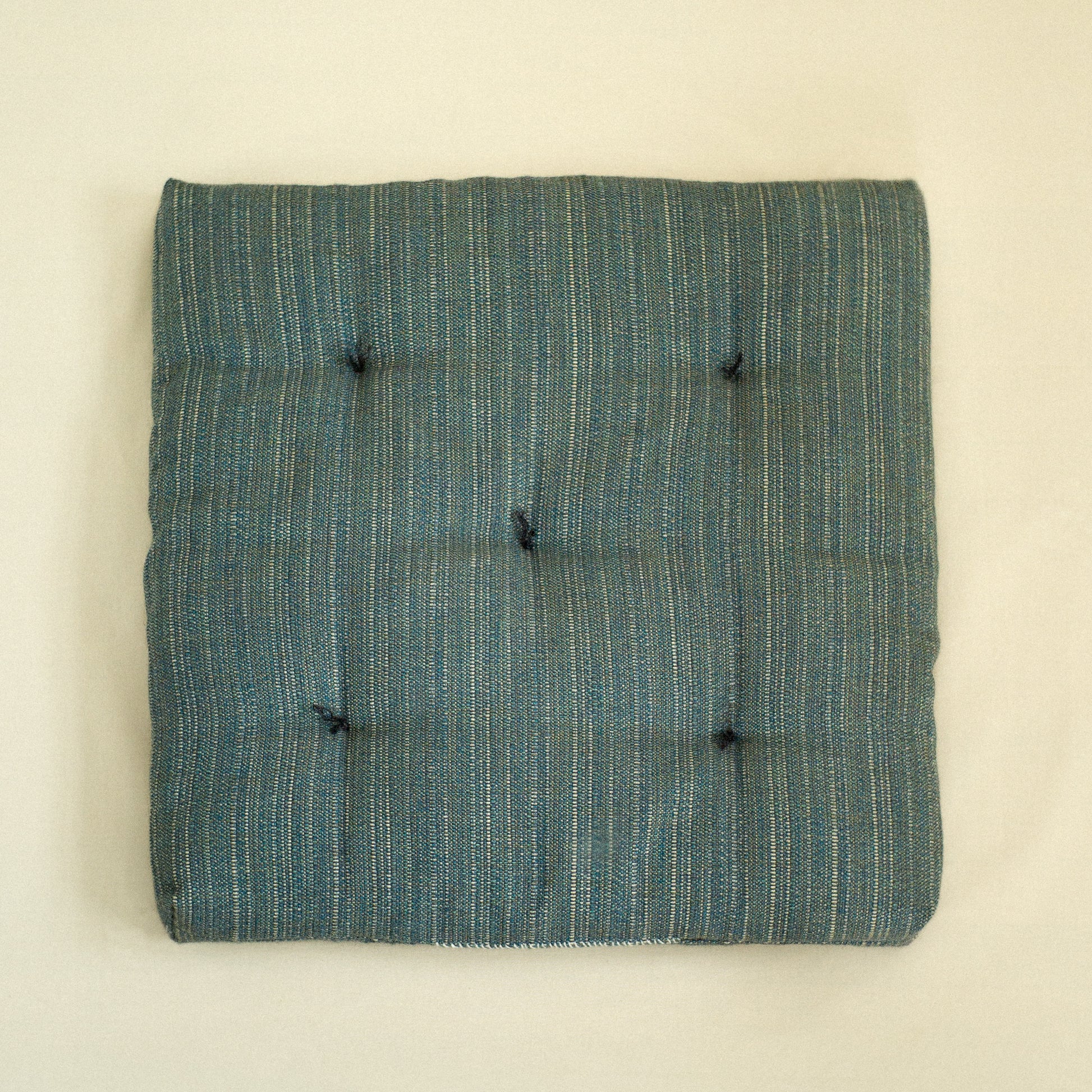 Teal textured dog bed with quilted detail filled with sheep wool.