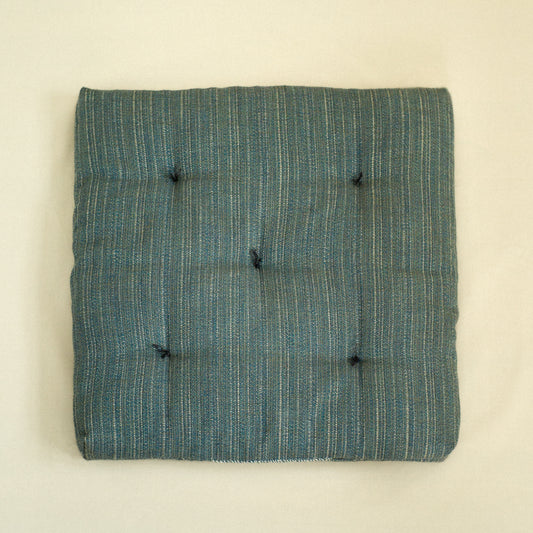 Teal textured dog bed with quilted detail filled with sheep wool.