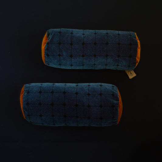 Two blue and orange velvet cylindrical pillows