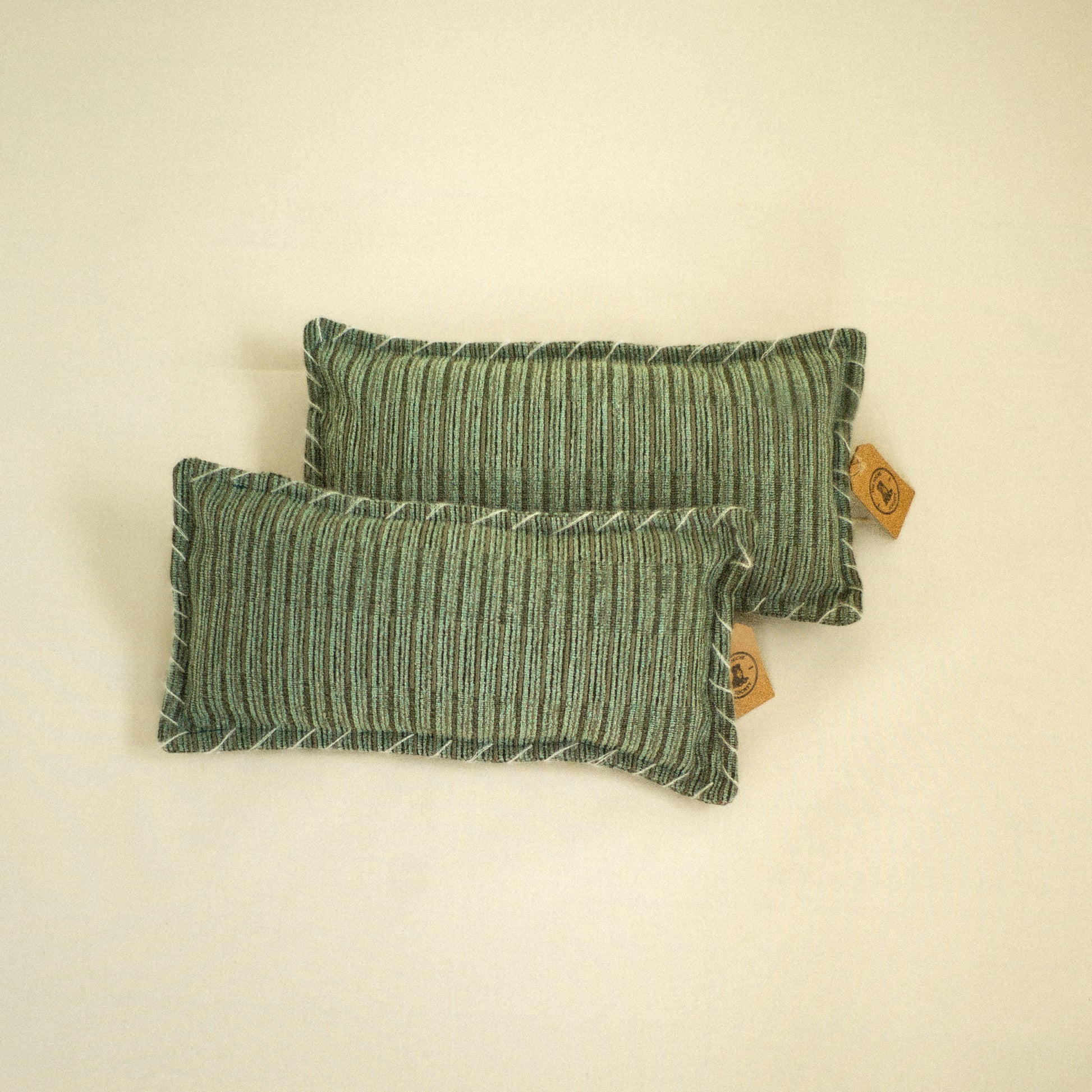 Two green velvet textured decorative pillows